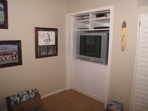 Downstairs bedroom two with built in for television